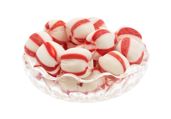Peppermint balls in a bowl isolated on a white background.