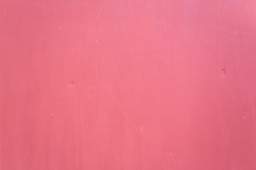 Close view of red painted plywood siding.