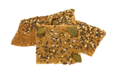 Whole wheat seeded crackers on a white background.