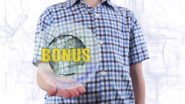 Young man shows a hologram of the planet Earth and text Bonus. Boy with future technology 3d projection on a modern white digital background