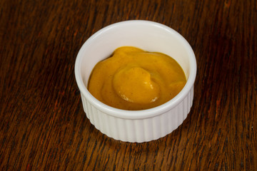 Mustard sauce over wooden