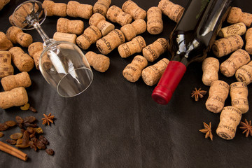 A lot of traffic jams, a glass and a bottle of wine lie on a dark background
