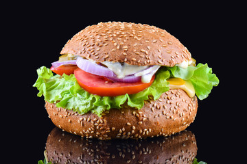 Fresh tasty burger on black background. Tasty and appetizing cheeseburger. Vegetarian burger
