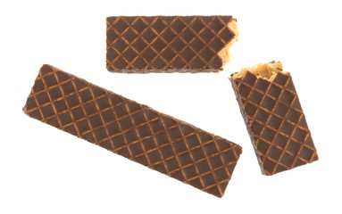 Broken chocolate covered peanut butter wafer cookies top view isolated on a white background.