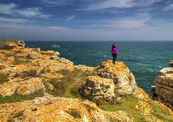 Happy young lady looking at beautiful landscape