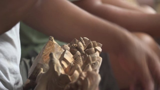 Asian wood carver working.