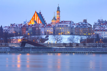 Fototapeta na wymiar Old Town with reflection in the Vistula River during evening blue hour, Warsaw, Poland.