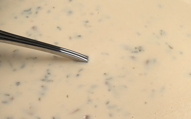 Creamy mushroom soup with a spoon in the food.
