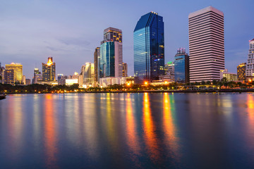 Fototapeta na wymiar Bangkok city downtown at twilight with reflection of skyline, Benjakiti Park, Bangkok,Thailand