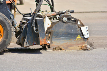 Professional machine car cuts the asphalt in the city