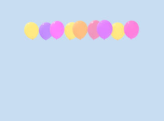 Colourful faded balloons yellow pink purple red soaring against light blue sky with copy space.