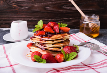 American pancakes with jam and fresh strawberries