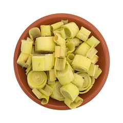 Top view of lemon grass sections in a small bowl isolated on a white background.