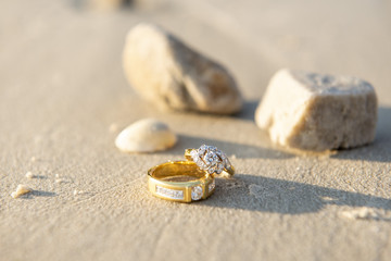 pair of wedding ring on beach
