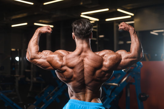 Handsome model muscle man abs workout in gym