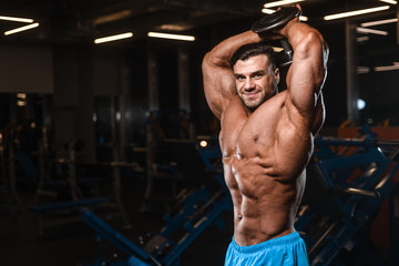 Handsome model muscle man abs workout in gym
