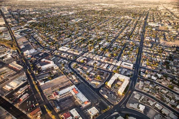 Foto op Plexiglas Aerial view across urban suburban communities seen from Las Vegas Nevada with streets, rooftops, and homes © littleny