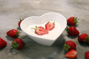 strawberry yogurt in bowl with fresh strawberries