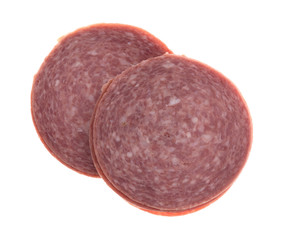 Genoa salami stacks on a white background.