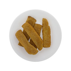 Top view of French toast sticks on a plate isolated on a white background.