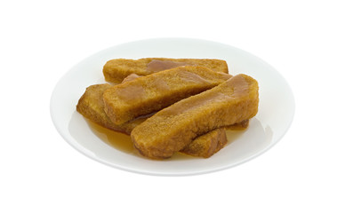 French toast sticks on a plate with syrup isolated on a white background.