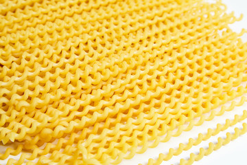 Raw fusilli bucati lunghi italian pasta on white background
