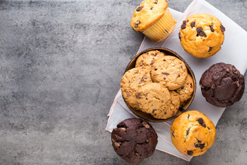 Homemade chocolate muffins on the vintage background.
