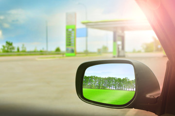 Refilling the car. The car drives up to the gas station. View from the driver's window. .