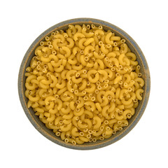 Top view of elbow macaroni in a stoneware bowl isolated on a white background.