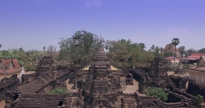  Aerial drone shot : fly down in the front of an old temple made of sandstone and laterite. It was built long before the legendary Angkor Wat temple in Siem Reap, but it was created in a similar style