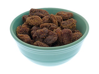 Dried strawberries in a green bowl isolated on a white background.