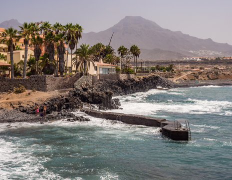 Blue sea waves crashing on the shore at Playa de la Enramada in Teneriffe, Spain EU