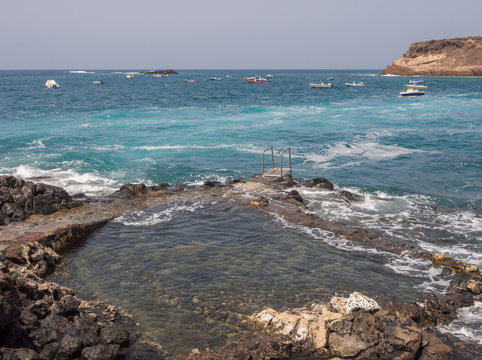 Blue sea waves crashing on the shore at Playa de la Enramada in Teneriffe, Spain EU