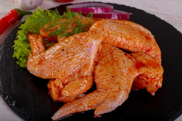 Raw marinated chicken wings