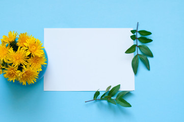 Bouquet of yellow flowers and place for text on a blue background, minimalism, greeting card