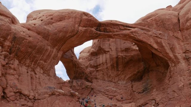 Tourists adventures at the Double Arch, Arches National Park, Utah, Usa, North America