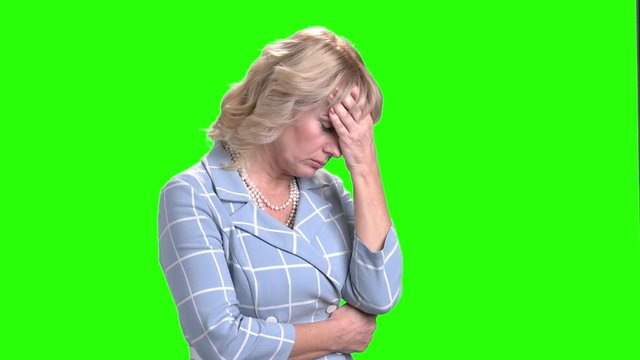 Tired woman on chroma key background. Mature business woman looking exhausted and frustrated. Stress and depression concept.