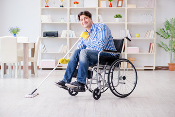 Disabled man on wheelchair cleaning home