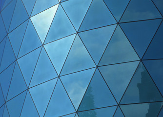 d windows panes reflecting the sky and clouds