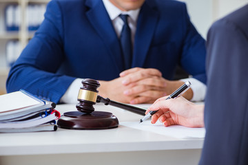 Lawyer talking to his client in office