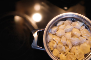 Cooking dumplings. Pot and boiling water, closeup.
