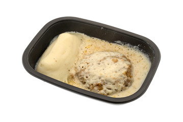 Fried beef steak with gravy TV dinner in a tray
