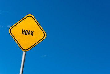 hoax - yellow sign with blue sky