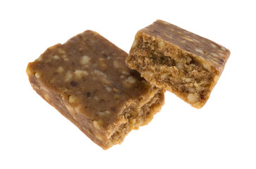 Cashew and date energy bar broken in half on a white background.