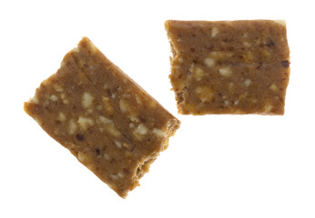 Top view of a cashew and date energy bar broken in half isolated on a white background.