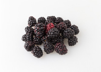 Blackberries on a white plastic cutting board