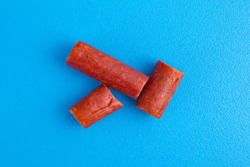 Bite size beef sausages on cutting board
