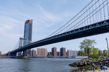 Side view of Manhattan Bridge structure and New York buildings