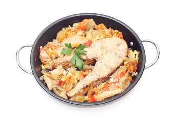 Fish steak fried with vegetables, isolated on white
