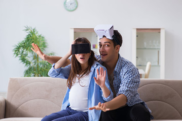 Young couple trying virtual reality glasses goggles